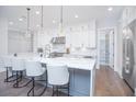 Bright kitchen boasts white cabinetry, stainless steel appliances, a large island, pendant lights, and a walk-in pantry at 13779 Abberwick Dr, Orlando, FL 32832