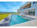 Backyard oasis featuring a sparkling pool, spa, outdoor seating, and a covered patio perfect for entertaining at 13779 Abberwick Dr, Orlando, FL 32832
