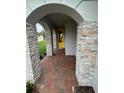 Inviting front entry with stone columns and brick pavers at 3185 Songbird Cir, Harmony, FL 34773
