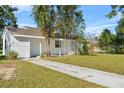 Quaint single-story house featuring a well-kept lawn and front porch with lots of curb appeal at 514 S 7Th St, Lake Wales, FL 33853