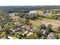 Aerial view of the property showcasing its location, surrounding landscape, and nearby lake at 7 Huntley Ct., Haines City, FL 33844