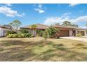 Well-maintained home exterior featuring a large yard at 7 Huntley Ct., Haines City, FL 33844