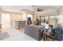 Spacious living room with hardwood floors, a cozy seating area, and access to a lanai at 7 Huntley Ct., Haines City, FL 33844
