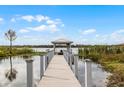 Wooden dock extending over calm water, offering scenic views at 2570 Oak St, Kissimmee, FL 34744