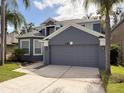 Charming two-story home features a two-car garage, lush landscaping, and a freshly painted exterior at 2806 Balforn Tower Way, Winter Garden, FL 34787