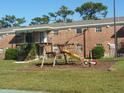 The exterior of a brick building with stairs, slide, and playground equipment at 5317 Curry Ford Rd # J101, Orlando, FL 32812