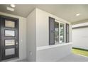 This home's entrance features a stylish front door and a window with decorative shutters at 2316 Citrus Bloom Dr, Bartow, FL 33830