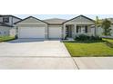 Charming single-Gathering home with a well-manicured lawn, two-car garage and a modern design at 2316 Citrus Bloom Dr, Bartow, FL 33830
