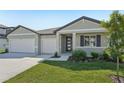 Charming single-Gathering home with a well-manicured lawn, two-car garage and a modern design at 2316 Citrus Bloom Dr, Bartow, FL 33830