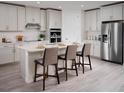 Modern kitchen featuring white cabinets and a large island at 2332 Citrus Bloom Dr, Bartow, FL 33830