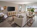Spacious living room with sectional sofa and water views at 2332 Citrus Bloom Dr, Bartow, FL 33830