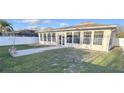Enclosed sunroom with lots of windows overlooking the grassy backyard at 2485 Huron Cir, Kissimmee, FL 34746