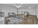 Living room with grey couch and kitchen view at 842 E Church Ave, Longwood, FL 32750