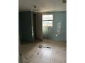 A simple bedroom with light teal walls and tile floor at 3108 Lawrence St, Orlando, FL 32805