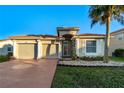 Two-car garage, front yard, and light-colored house at 3151 Riachuelo Ln, Kissimmee, FL 34744