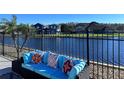 Comfortable outdoor seating with decorative pillows and a peaceful lake view at 3301 Buckingham Way, St Cloud, FL 34772