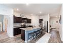 Modern kitchen featuring granite countertops, dark wood cabinets, and a stainless steel refrigerator and appliances at 538 Stowers Dr, New Smyrna Beach, FL 32168