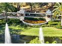 Aerial view of Magnolia Plantation entrance, featuring water fountains and manicured landscape at 1446 Foxtail Ct, Lake Mary, FL 32746