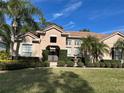 Charming home featuring lush landscaping, a tiled roof, and a welcoming double-door entrance at 1446 Foxtail Ct, Lake Mary, FL 32746