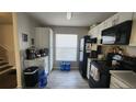 Well-equipped kitchen, white cabinets, black appliances at 1724 Silver Creek Ct # 105, Orlando, FL 32807