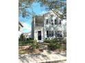 Two-story light blue house with black shutters, a front porch, and landscaping at 3929 Corrine Dr, Orlando, FL 32814
