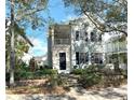 Two-story light blue house with black shutters, a front porch, and landscaping at 3929 Corrine Dr, Orlando, FL 32814