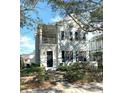 Two-story light blue house with black shutters, a front porch, and landscaping at 3929 Corrine Dr, Orlando, FL 32814