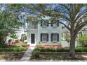 Two-story home with a covered balcony and beautiful landscaping at 3929 Corrine Dr, Orlando, FL 32814