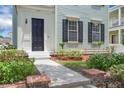 Close-up of the home's front door and manicured landscaping at 3929 Corrine Dr, Orlando, FL 32814