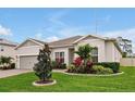 Attractive home featuring a well-maintained lawn, lovely landscaping, and a brick paver driveway at 4223 Sunset Preserve Blvd, Orlando, FL 32820