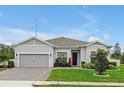 Beautiful single-story home with a two-car garage and an inviting landscaped front yard with garden beds at 4223 Sunset Preserve Blvd, Orlando, FL 32820