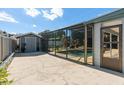 Outdoor screened-in pool area featuring a storage shed and a patio at 5138 Andrea Blvd, Orlando, FL 32807