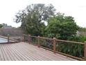 Spacious deck with wood railings, overlooking lush trees at 9130 Dollanger Ct, Orlando, FL 32819