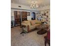 Spacious living room with built-in shelving, comfortable seating, and a large chandelier at 9130 Dollanger Ct, Orlando, FL 32819