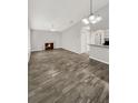 Open living room featuring a fireplace and wood-look tile floors at 105 Northlake Dr # 105, Sanford, FL 32773