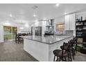 Bright kitchen boasts granite countertops, stainless steel appliances, modern cabinets, and a breakfast bar at 1208 Old Apopka Rd, Apopka, FL 32703