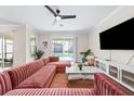 Spacious living room with large sectional sofa and flat-screen TV at 2763 Oxymoron Way, Kissimmee, FL 34746