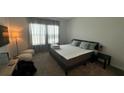 Spacious bedroom with king-size bed, two pillows, and ample natural light at 3203 Laurent Loop, Davenport, FL 33837