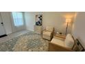 Cozy living room with two armchairs, side table, and patterned rug at 3203 Laurent Loop, Davenport, FL 33837