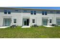 Three townhouses with private patios and small grassy backyards at 3207 Laurent Loop, Davenport, FL 33837