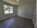 Bright, clean bedroom with tile floors and large window letting in natural light at 0 Robinson Dr, Haines City, FL 33844