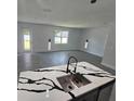 Open-concept kitchen with island and quartz counters that overlooks the living area at 0 Robinson Dr, Haines City, FL 33844