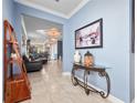 Bright entryway with console table and view into living area at 3570 Southern Cross Loop, Kissimmee, FL 34744