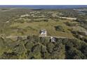 An aerial view of the property showing the house, land, nearby trees, and the neighborhood at 3705 Ridge Run Dr, Minneola, FL 34715