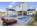 Gorgeous backyard area with a pool, patio, outdoor furniture, and a cozy lounge area at 3705 Ridge Run Dr, Minneola, FL 34715