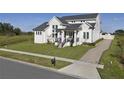 A well-manicured lawn leads to this two-story modern home with black accents, stone walkway, and a driveway at 3705 Ridge Run Dr, Minneola, FL 34715