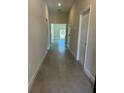 Inviting hallway featuring neutral walls, tile flooring, and access to various rooms within the home at 1629 Pear Ave, Sanford, FL 32771