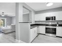 Modern kitchen with white cabinets, stainless steel appliances, and dark countertops at 304 E South St # 5029, Orlando, FL 32801