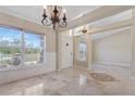 Inviting foyer featuring gleaming tile floors, large windows, and a charming chandelier that creates a warm ambiance at 3871 Dallas Blvd, Orlando, FL 32833