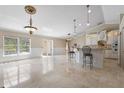 Bright and airy living room featuring elegant marble floors, a kitchen bar, and seamless access to outdoor spaces at 3871 Dallas Blvd, Orlando, FL 32833